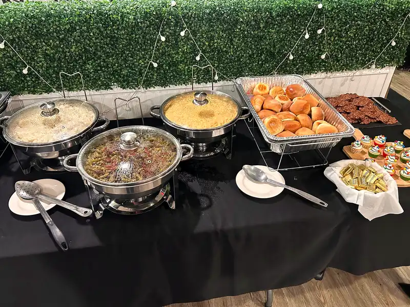 A catering buffet of chafing dishes with home-style sides