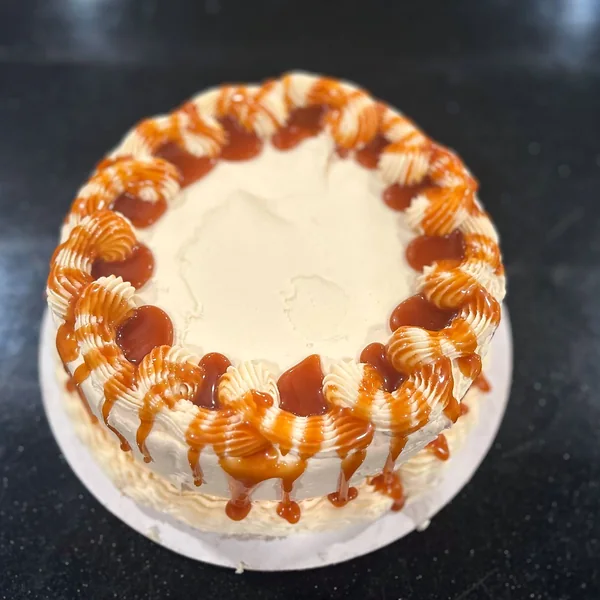 A frosted cake with caramel drizzle