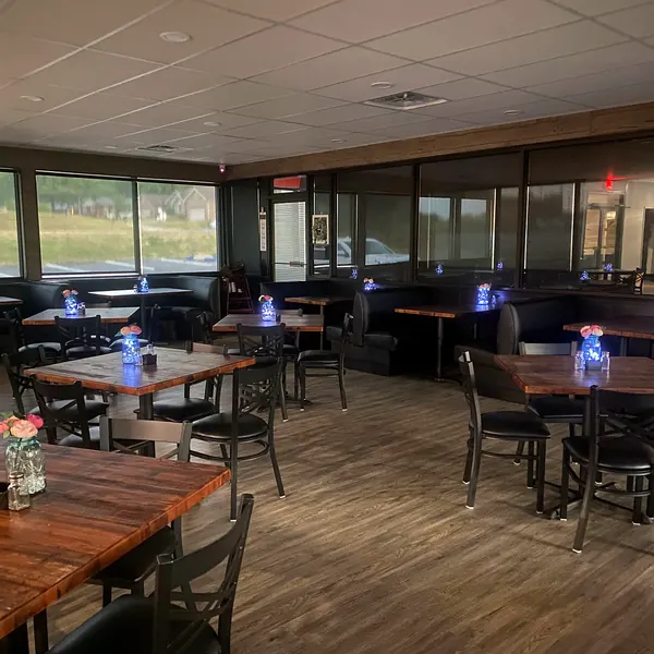 The Rooster’s Den dining room with wood tables and big windows
