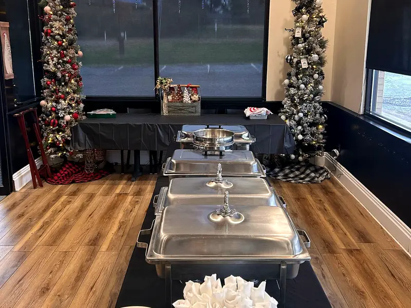 The event room set with a buffet line and a long party table