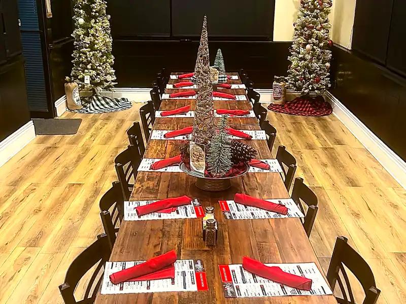 A long table set for a party in The Rooster’s Den event space