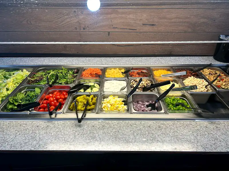 The all-you-can-eat salad bar with fresh greens and toppings